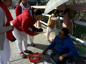 Distributing warm  sweater at the roadside
